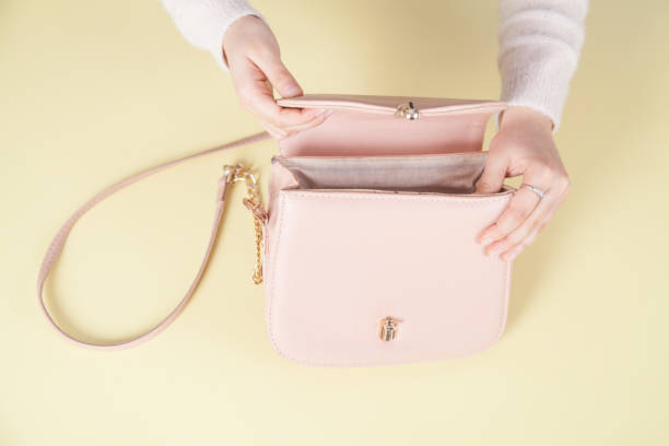 istock Girl holding handbag on yellow background. 1292376722