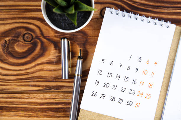 istock white calendar for 2021 month schedule to make an appointment or manage the schedule every day on a wooden table with succulent and ballpoint pen for marks, for work planning 1292377787