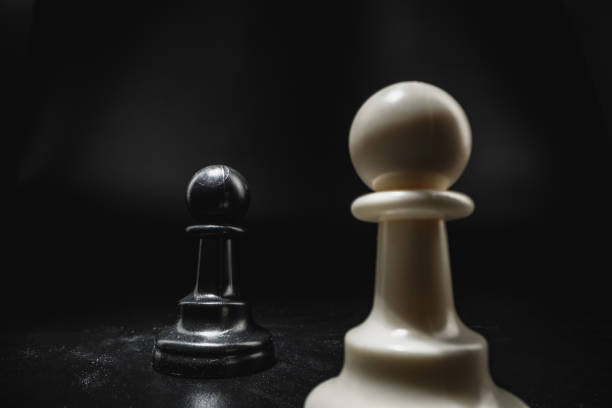 istock Chess game with chess pieces against black background 1292377931