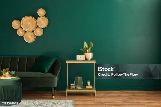 Elegant Living Room Interior With Modern Design Green Velvet Sofa Furniture Gold Decoration Plant Carpet Copy Space Pillow And Stylish Personal Accessories Template Stock Photo - Download Image Now