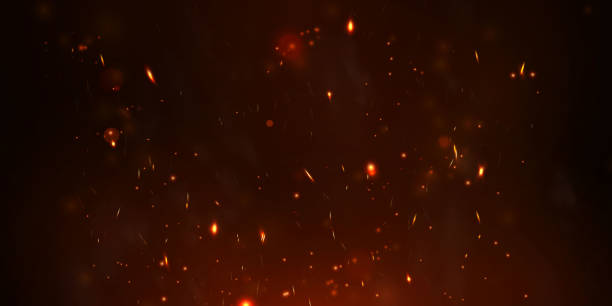 istock Sparks fly up Glowing particles on a black background and with flames 1292378138