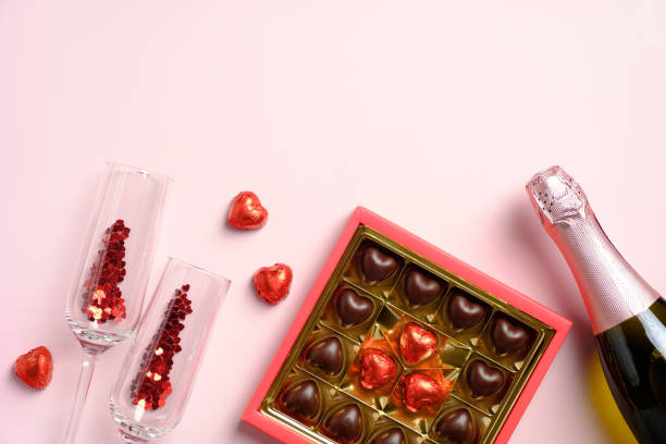 istock Happy Valentines Day composition. Flat lay, top view champagne bottle, glasses, sweets on pink table. Love, romance concept. 1292381316
