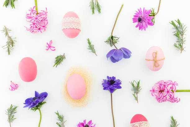 istock Ester holiday composition with colorful eggs, spring flowers, hypericum and leaves of lavender on white background. Flat lay, top view 1292381599