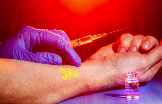 istock Conspiracy theory concept with identification chip being implanted in patient's arm during COVID-19 vaccination 1292382625