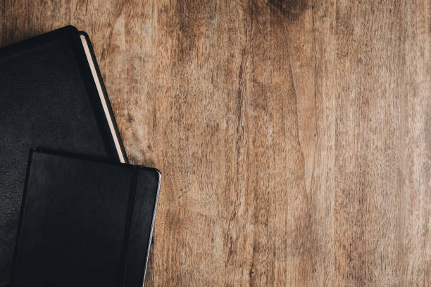 istock A Bible and a notebook on a wooden desk. Top view flat lay. 1292383632