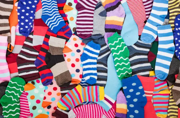 Photo of Different multicolored bright socks. Abstract background image.