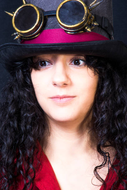 istock Beautiful woman with hat  on black background 1292387663
