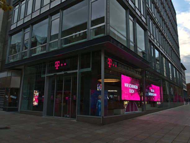 Closed shop of telecommunications company Deutsche Telekom in shopping street Königstraße during Covid-19 lockdown. Text on screen: We give you 100 GB data volume. stock photo