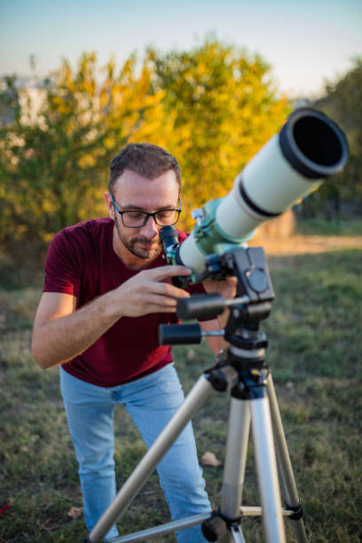 istock Amateur astronomer looking at the sky with a telescope. 1292389066