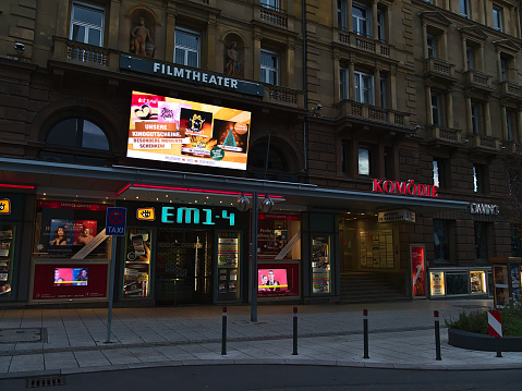 Stuttgart, Germany - 12-19-2020: Entrance of cinema auditoriums EM of Innenstadtkinos in historic old building in downtown currently closed due to Covid-19 lockdown: Text on screen: Ad for coupons.