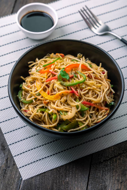 istock stir fried vegetarian noodles in a black bowl  with sauce 1292391448
