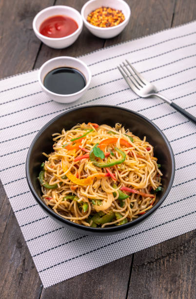istock stir fried vegetarian noodles in a black bowl  with sauce 1292391499
