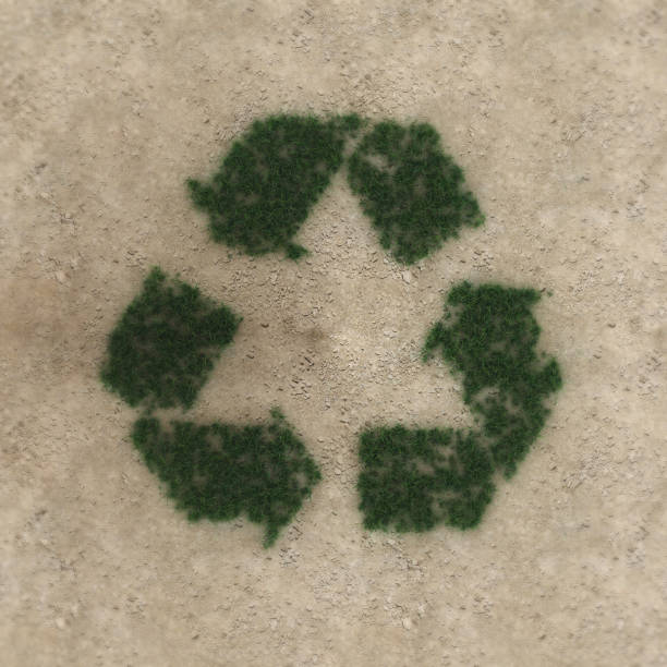 istock Grass recycle sign on dry soil ecological background 1292391747