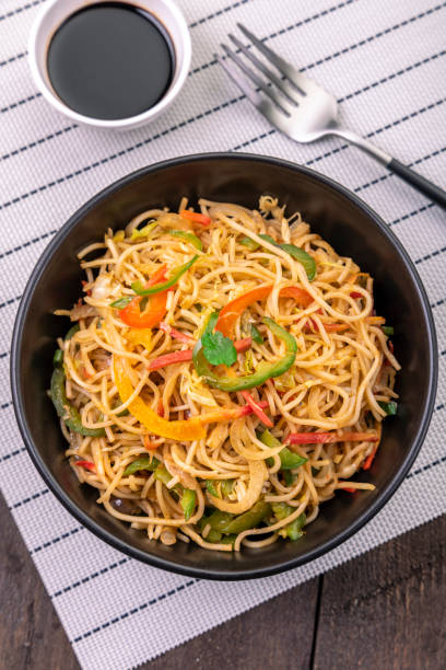 istock stir fried vegetarian noodles in a black bowl  with sauce 1292392020