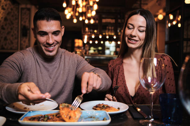 istock Young couple on a date at the restaurant. 1292393122
