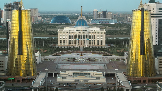 ASTANA, KAZAKHSTAN - JULY 2016: A square in front of Ak Orda with Altyn Orda business center in the foreground timelapse. Top view from bayterek. Ak Orda is the presidential residence in Astana, the capital of Kazakhstan.