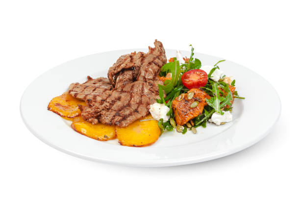 istock Grilled beef slices with fried potatoes on white background 1292397019