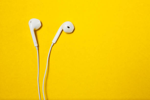 istock White wired headphones on yellow background with place for text 1292397262