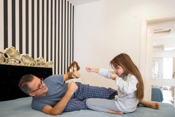 istock Dad with daughter in bedroom 1292397306
