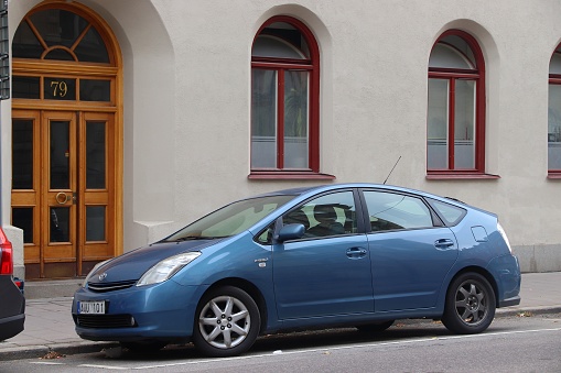 Blue Toyota Prius hybrid compact car parked in Stockholm, Sweden. There are 4.8 million passenger cars registered in Sweden.