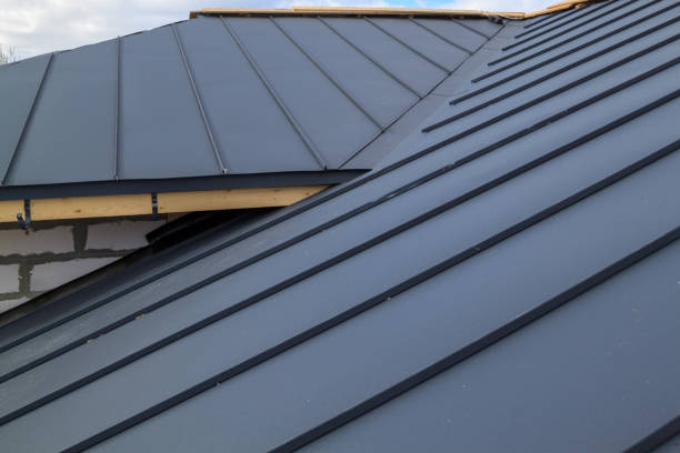 close up view of  house under construction with grey folding roof on waterproofing layer stock photo