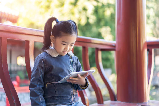 istock Little girl holding an tablet computer 1292399527
