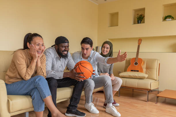 istock Enthusiastic Multi-Ethnic Friends are Supporting Basketball Team from Home. 1292400620