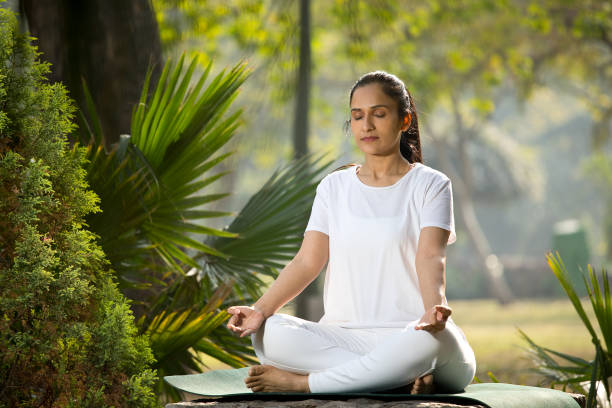 istock Woman meditating at park 1292400683