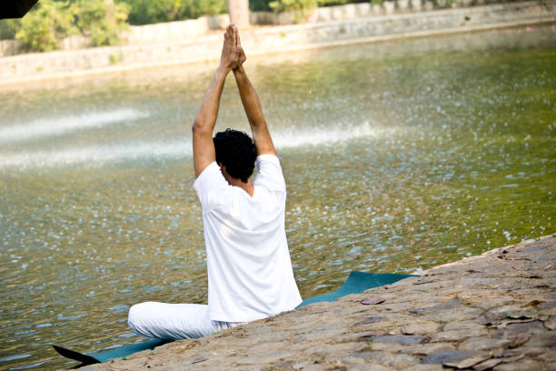 Man in yoga pose at park