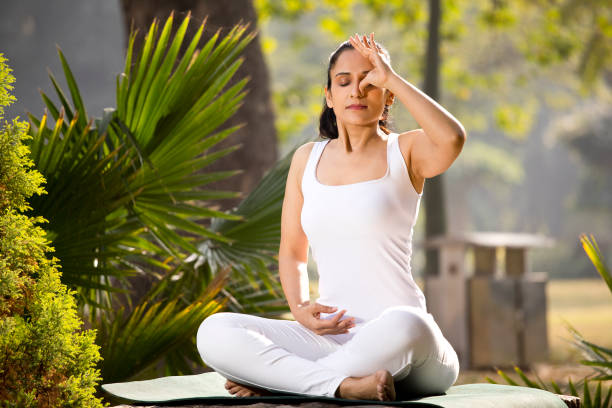 istock Woman meditating at park 1292401701