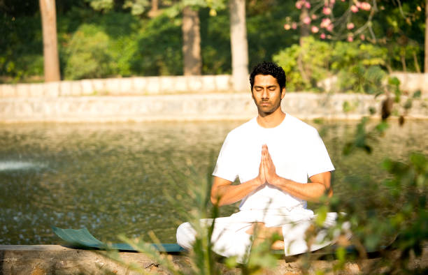 istock Man in yoga pose at park 1292402727
