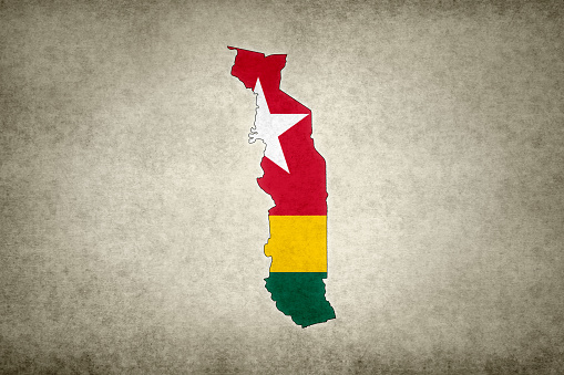 Grunge map of Togo with its flag printed within its border on an old paper.