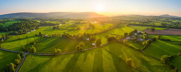 aerial panorama over idyllic rural landscape farms fields golden sunlight - river usk imagens e fotografias de stock