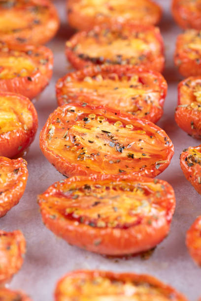 istock Roasted tomatoes are lined up on a baking sheet 1292404555