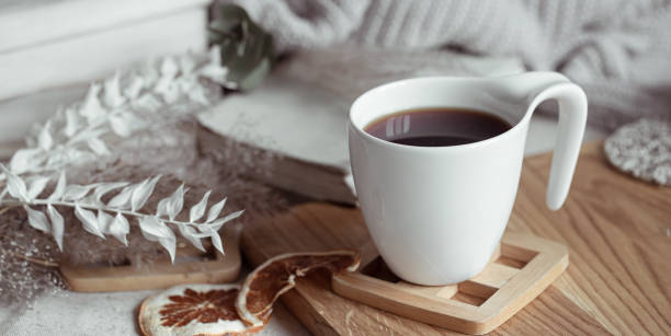 istock Close up of a white cup with a hot drink on a blurred background. 1292406716