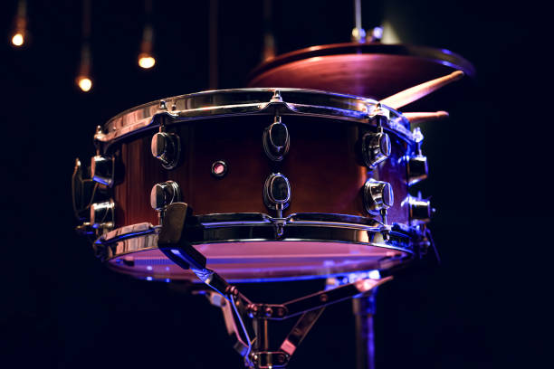 istock Snare drum and drumsticks close up in dark. 1292406882