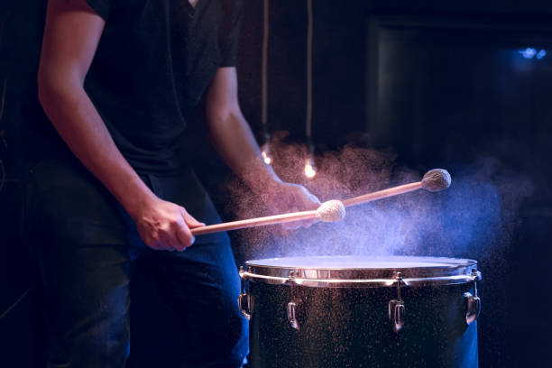 istock The drummer plays with mallets on floor tom in dark room. 1292406885