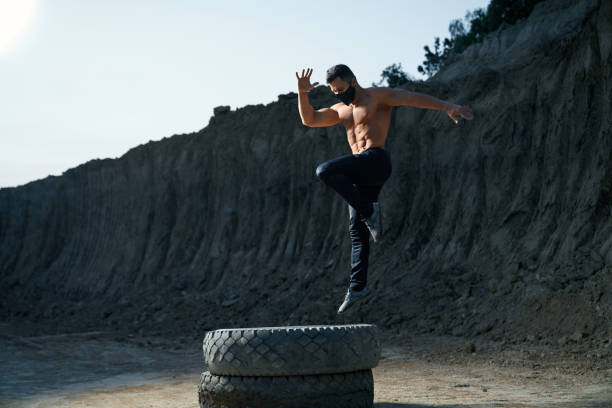 istock Shirtless bodybuilder in face mask having evening workout 1292407164