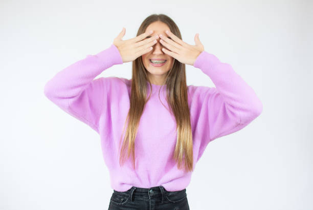istock Pretty brunette woman covering her face with both hands 1292408830