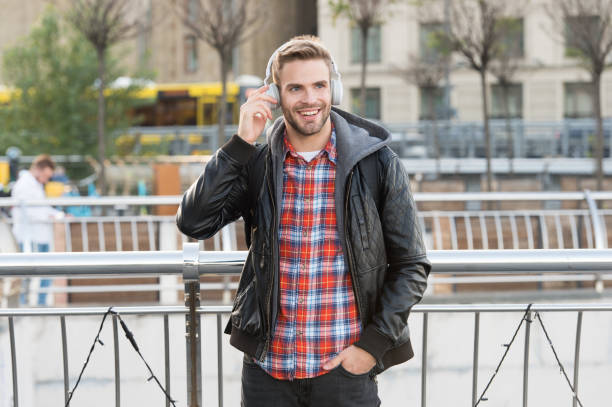 istock Self improve. Handsome man enjoy music urban background. Distance education. Remote studying. Modern education. Podcast for youth. Online education courses. Listen music. Student study use headphones 1292408865