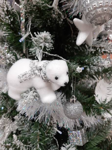 istock Decoration white teddy bear on a christmas tree 1292409798