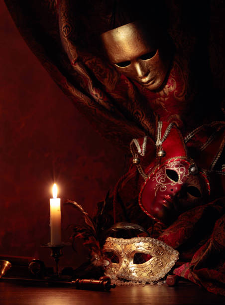istock Carnival masks, dice and small brass candlestick with burning candle. 1292409800