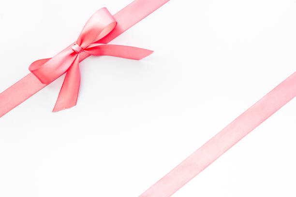 istock Pink ribbon with bow isolated on white. Top view, copy space 1292412747