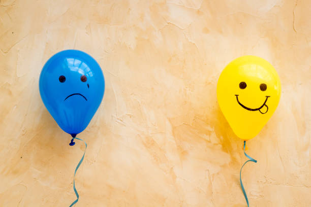 istock Emotions concept - happiness and sadness on the colored ballons. Top view 1292412899