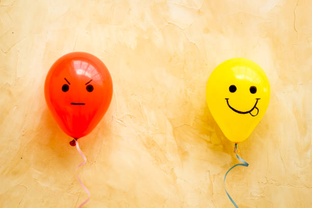 istock Emotions concept - happiness and anger on the colored ballons. Top view 1292412972