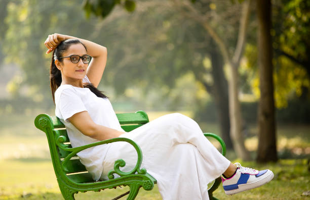 Woman sitting on bench at park