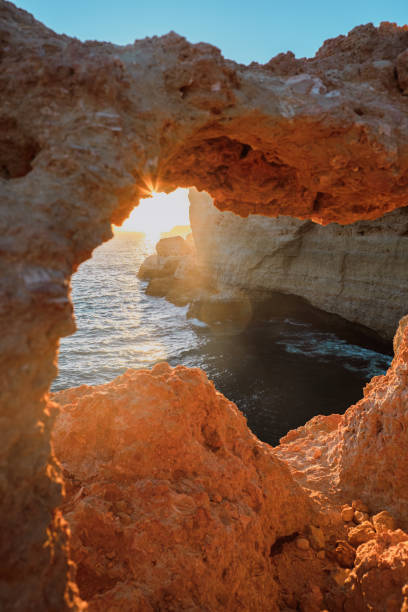 istock Sun shining through the cliffs in Algarve 1292414151