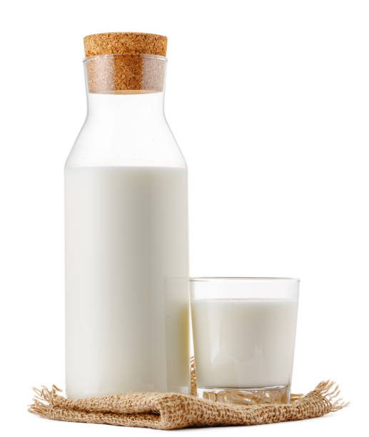 istock Closed glass milk bottle isolated on white background 1292414623