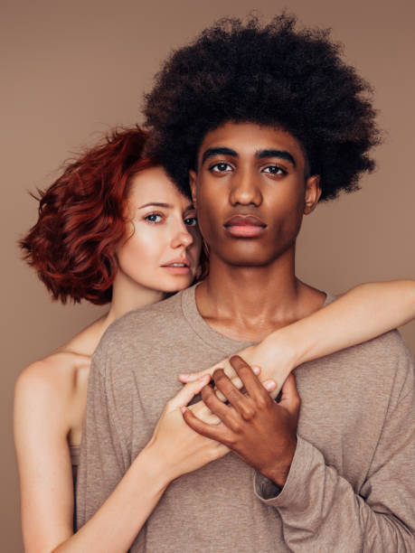 istock Interracial couple smiling and holding one another 1292415663