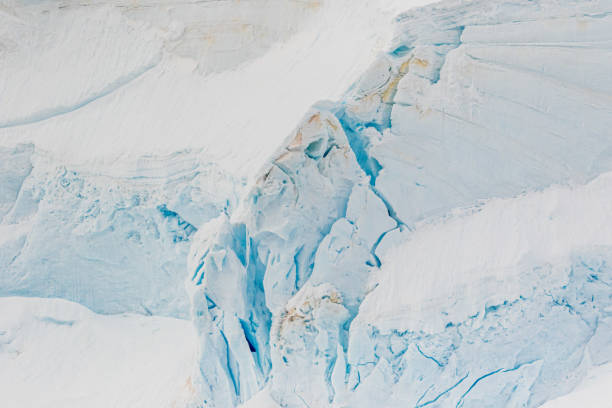 istock Blue crack in a glacier in Antarctica. A break in the glacier. Global warming. 1292415896